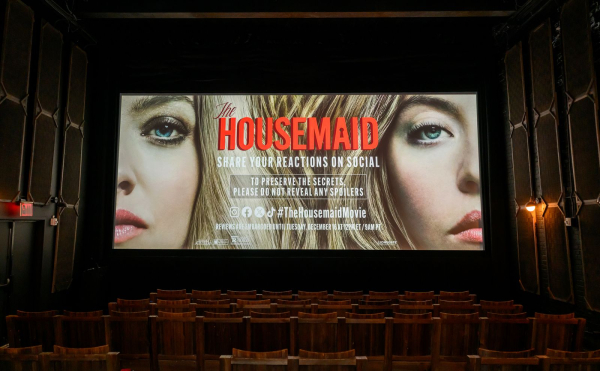 Photo of the theater screen displaying the title card of The Housemaid.